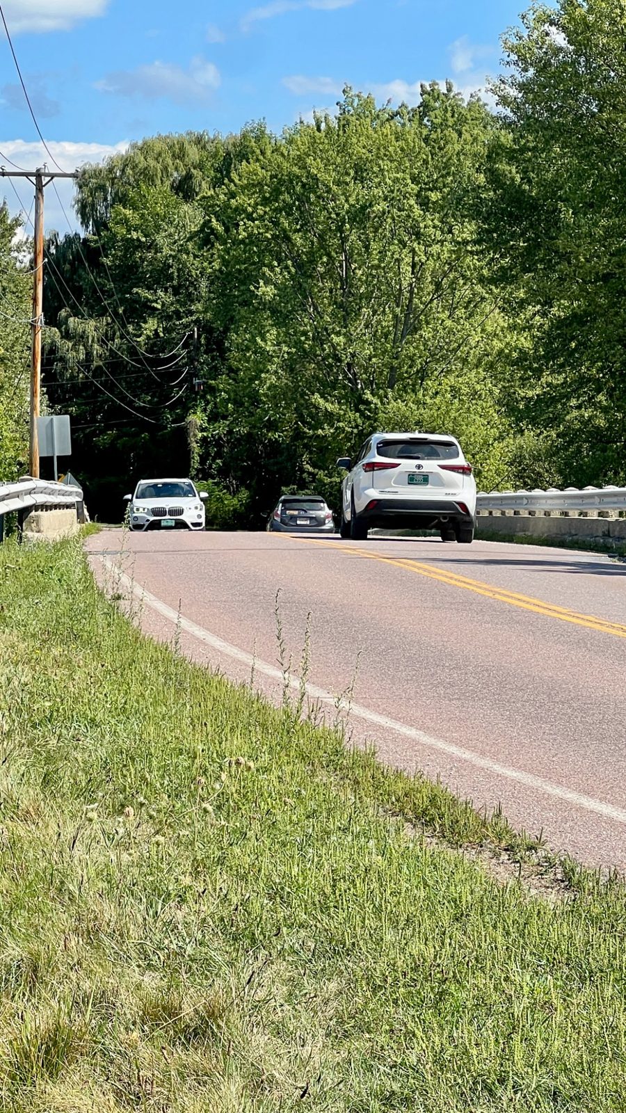 Traffic queued at the bridge crossing on Bay Road, guardrail on both approaches and no room to walk
